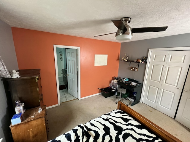 carpeted bedroom with ceiling fan, a textured ceiling, and a closet