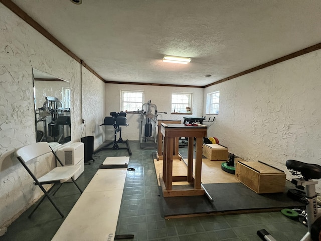 workout area with a textured ceiling and crown molding