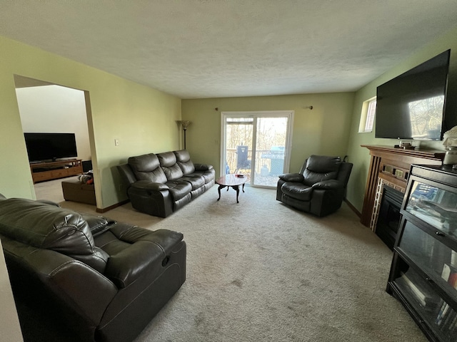 carpeted living room featuring a textured ceiling