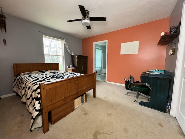 carpeted bedroom with connected bathroom and ceiling fan