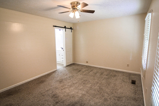 5780 Catawba Ln, Morristown, TN 37814 - carpeted spare room featuring a ceiling fan, a barn door, and plenty of natural light