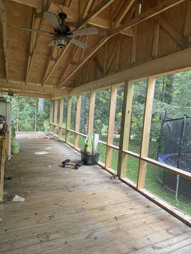 unfurnished sunroom with ceiling fan