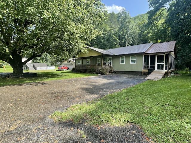 ranch-style house with a front yard and a porch