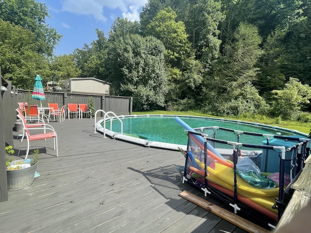 view of swimming pool featuring a deck