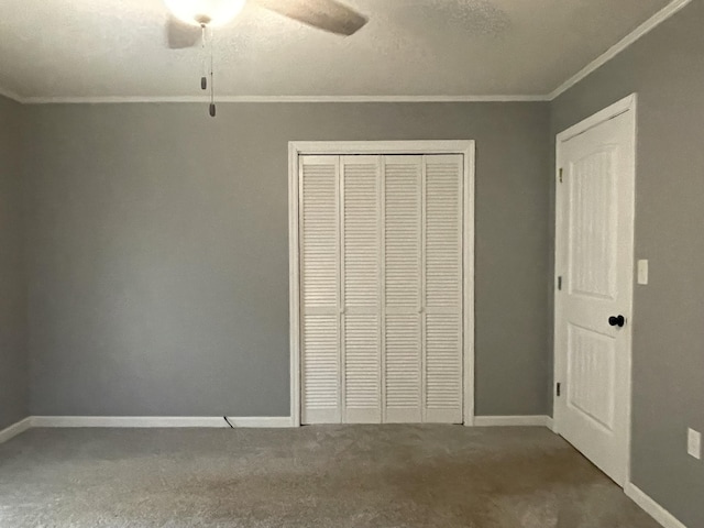 unfurnished bedroom with carpet flooring, ceiling fan, a closet, and ornamental molding