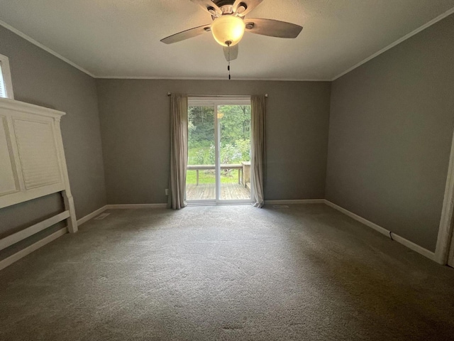 carpeted spare room with ceiling fan and crown molding