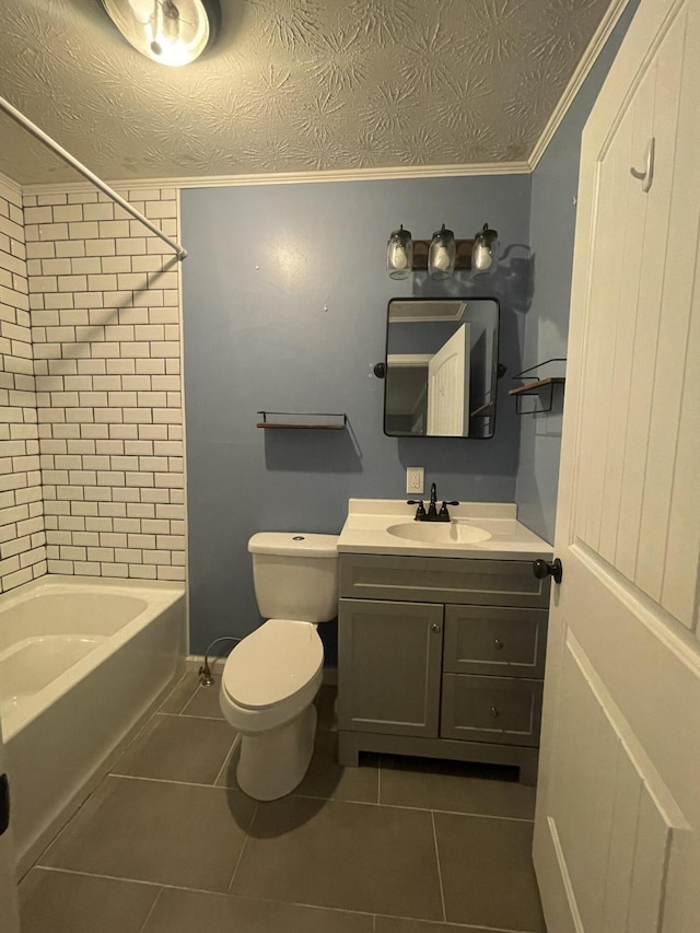 full bathroom featuring vanity, tile patterned floors, crown molding, tiled shower / bath combo, and toilet