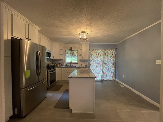 kitchen featuring white cabinets, a center island, light stone countertops, and appliances with stainless steel finishes