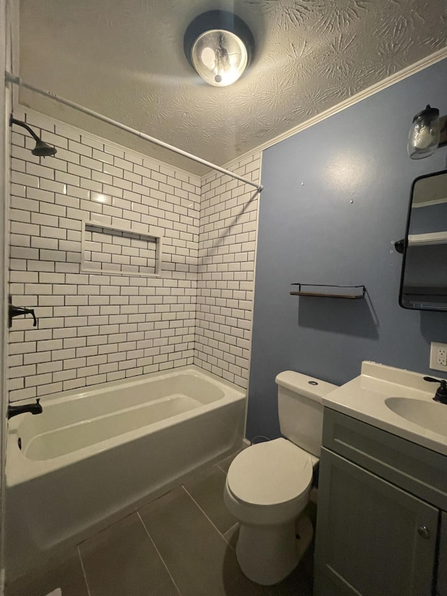 full bathroom with vanity, tile patterned flooring, tiled shower / bath combo, toilet, and a textured ceiling