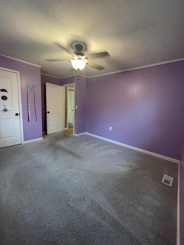 unfurnished bedroom with carpet, a textured ceiling, ceiling fan, and ornamental molding