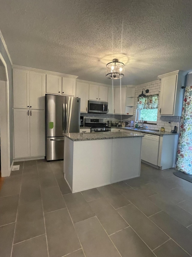 kitchen featuring white cabinetry, a center island, and stainless steel appliances