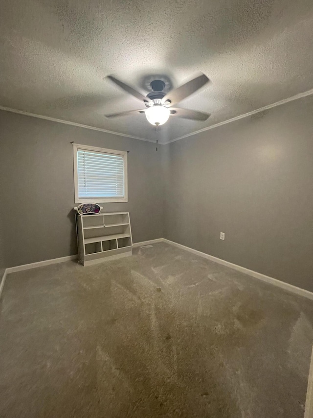 empty room featuring carpet flooring, a textured ceiling, ceiling fan, and crown molding