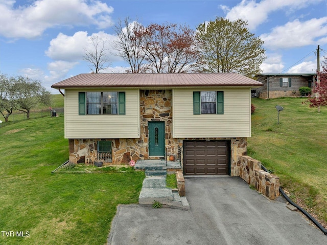 bi-level home with stone siding, a front yard, and metal roof