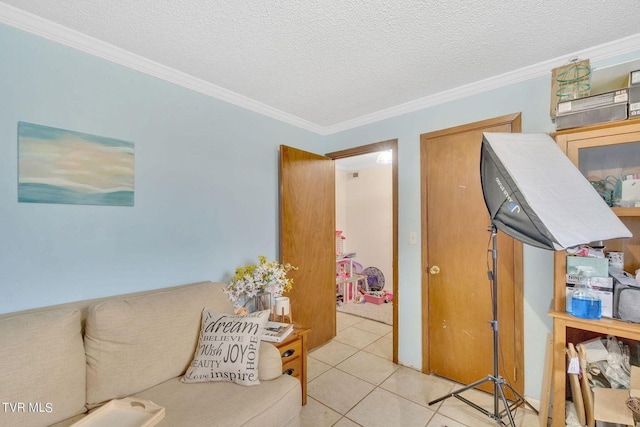 interior space with a textured ceiling, ornamental molding, and light tile patterned floors