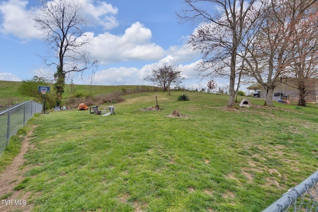 view of yard featuring fence and a rural view