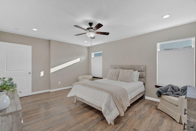 bedroom with recessed lighting, baseboards, and wood finished floors