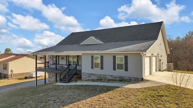 view of front of house with driveway, central AC unit, roof with shingles, a porch, and a front yard