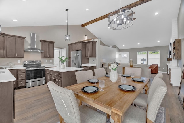 dining room with a notable chandelier, recessed lighting, beam ceiling, and light wood-style floors