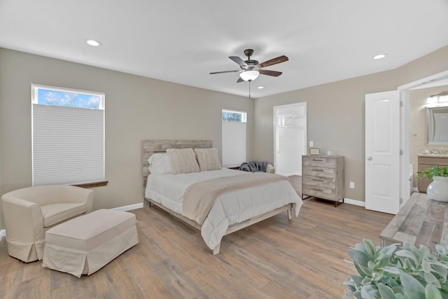 bedroom featuring baseboards, ceiling fan, wood finished floors, a spacious closet, and recessed lighting