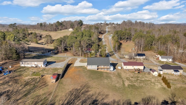 birds eye view of property with a wooded view