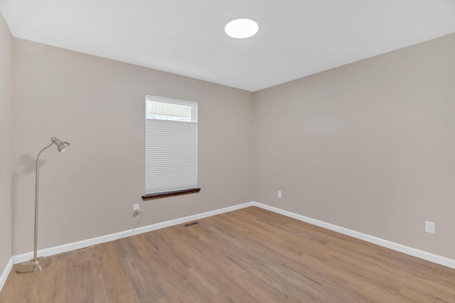 empty room featuring light wood-style floors and baseboards