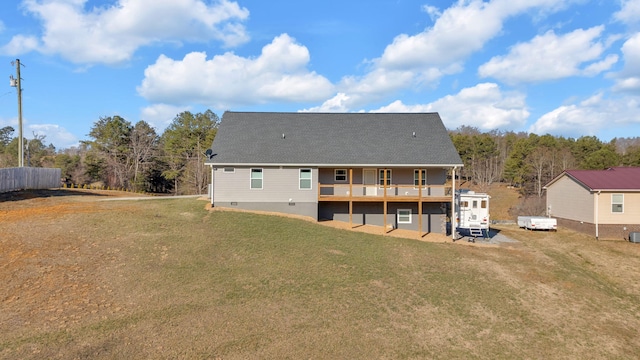 rear view of property featuring a yard and a deck