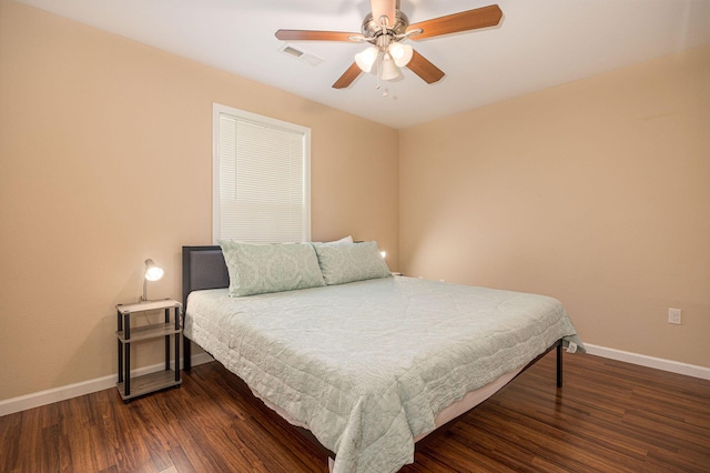 bedroom featuring visible vents, dark wood-style flooring, and baseboards