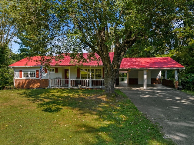 ranch-style house featuring brick siding, an attached carport, a front lawn, aphalt driveway, and a porch