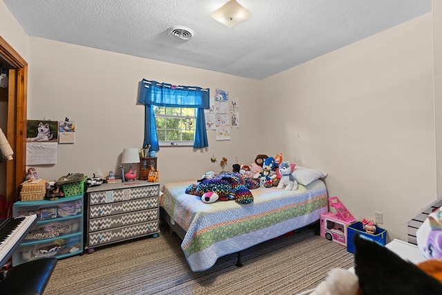 bedroom with visible vents, carpet floors, and a textured ceiling