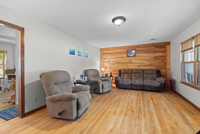 living room with baseboards and wood finished floors