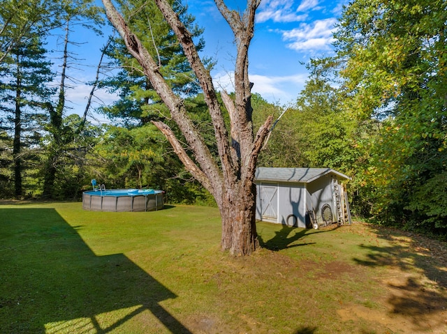 view of yard featuring an outbuilding and an outdoor pool