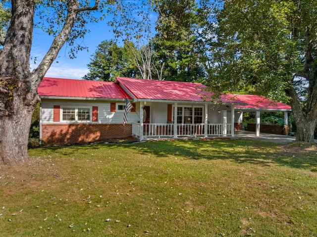 ranch-style home with a front lawn, a porch, metal roof, a carport, and brick siding