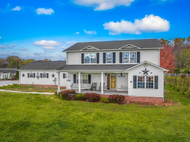 view of front of property with covered porch and a front lawn