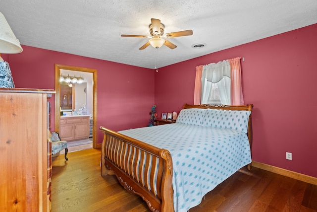 bedroom with connected bathroom, ceiling fan, wood-type flooring, and a textured ceiling