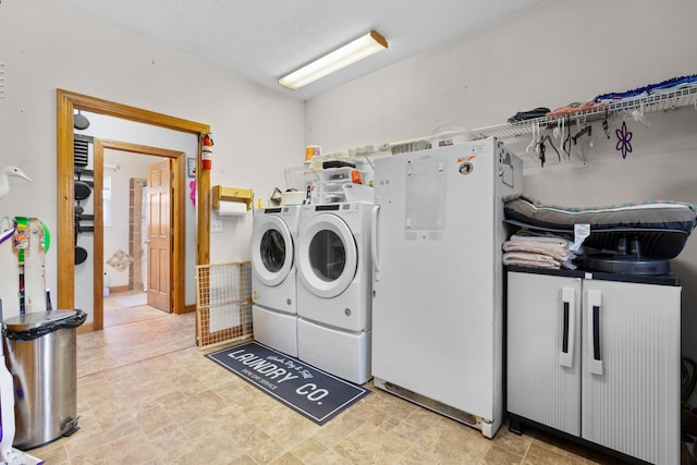 laundry room featuring washing machine and clothes dryer