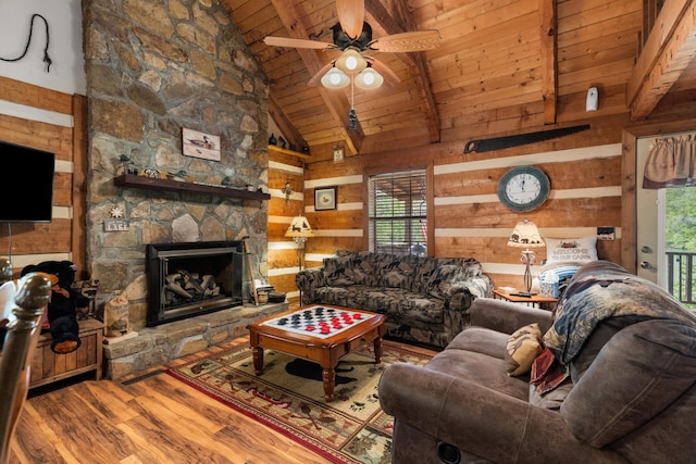 1055 Dean Cir, Dandridge, TN 37725 - living area with wood ceiling, wood finished floors, wood walls, a ceiling fan, and a stone fireplace