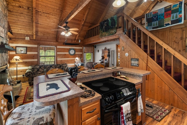 1055 Dean Cir, Dandridge, TN 37725 - kitchen featuring black range with electric cooktop, ceiling fan, a wood ceiling with exposed beams, wood finished floors, and wooden walls
