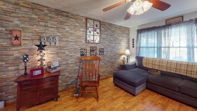 living room featuring ceiling fan and light hardwood / wood-style flooring