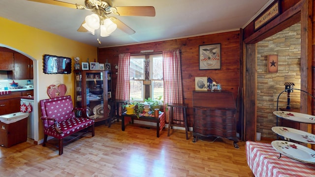 sitting room featuring light wood-type flooring and ceiling fan