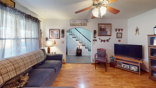 living room with ceiling fan and light hardwood / wood-style flooring