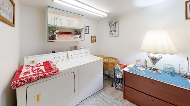 laundry room featuring separate washer and dryer and light wood-type flooring