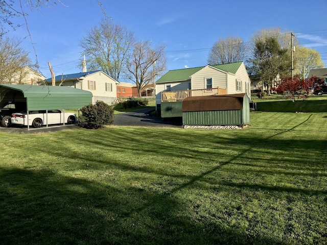 view of yard featuring a residential view, a deck, and a carport