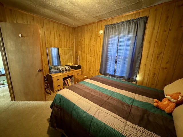 bedroom featuring carpet floors, wooden walls, and a textured ceiling