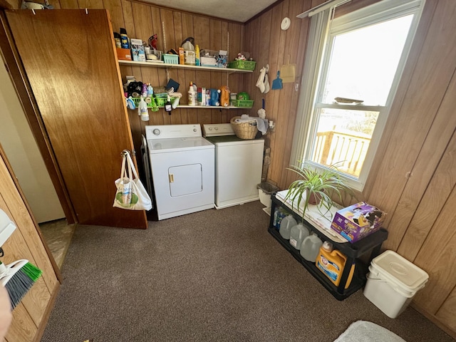 washroom featuring laundry area, washing machine and clothes dryer, and wooden walls