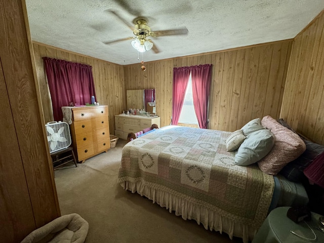 bedroom with light carpet, wood walls, and a textured ceiling