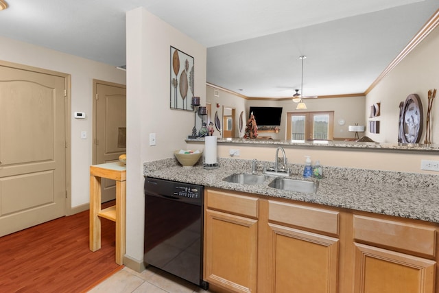 kitchen featuring sink, light hardwood / wood-style flooring, black dishwasher, and light stone counters