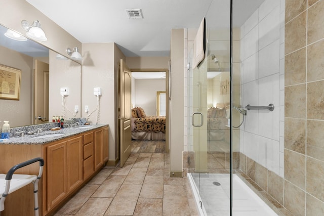 bathroom featuring a shower with shower door and vanity