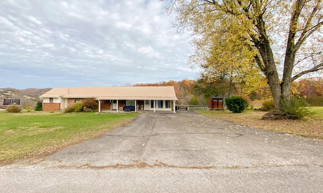 single story home with a front lawn and a carport