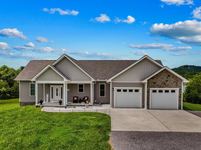 2139 Rainwater Rd, Dandridge, TN 37725 - view of front of property featuring a front yard, roof with shingles, a garage, and concrete driveway