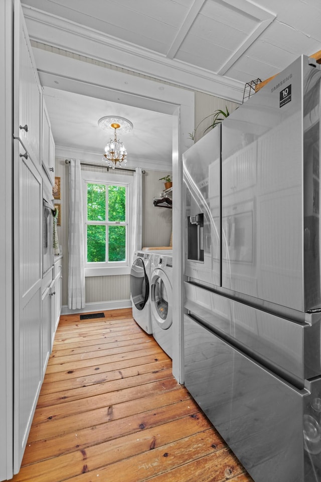 1130 Squirewood Way, Dandridge, TN 37725 - laundry room featuring washer and dryer, light wood-type flooring, a chandelier, and ornamental molding